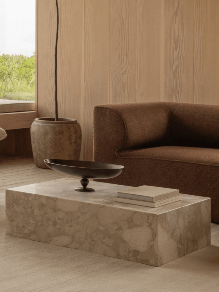 Audo's Kunis Breccia Plinth Coffee Table with an Eos Bowl and brown