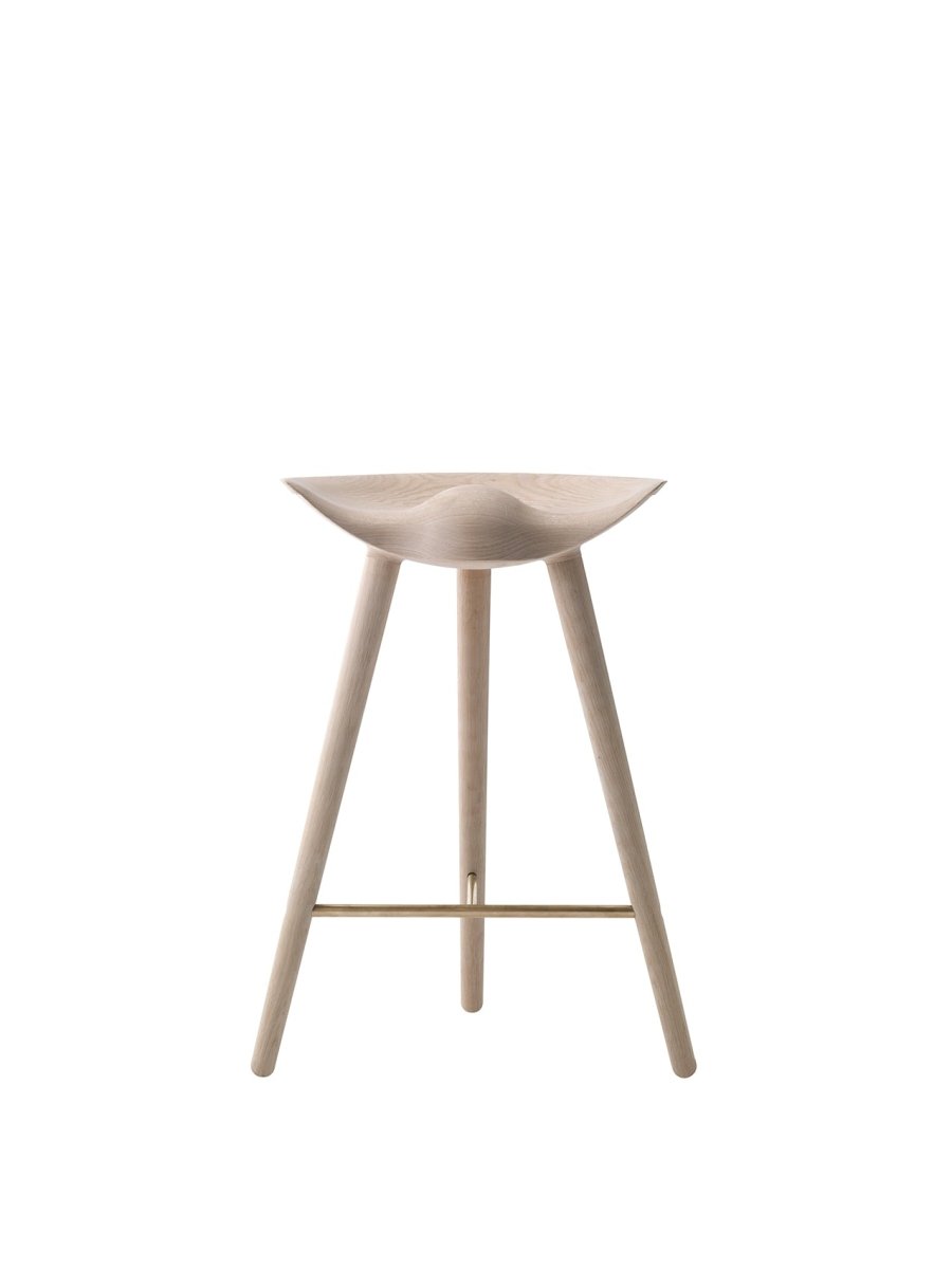 By Lassen ML42 counter stool in light oak with slender wooden legs and a brass footrest against a plain background.