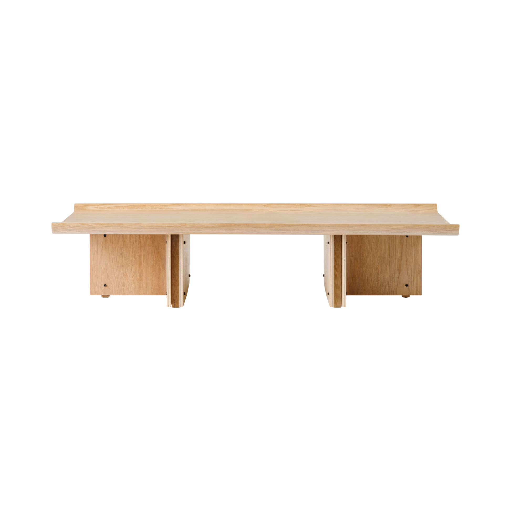 Front view of the architectural Conrad Lounge Table in natural oak, showing its curved veneer top and solid wood base.